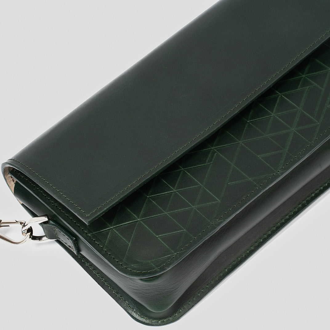 dark green leather shoulder bag with a geometric pattern