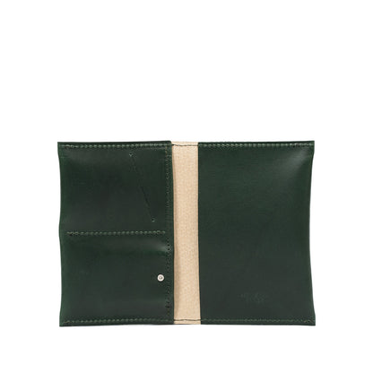 Green leather AirTag passport holder 2.0 featuring multiple storage slots