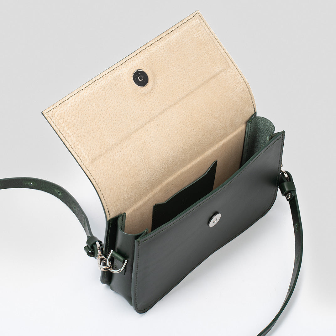 dark green leather shoulder bag with a minimalist and elegant design, interior view