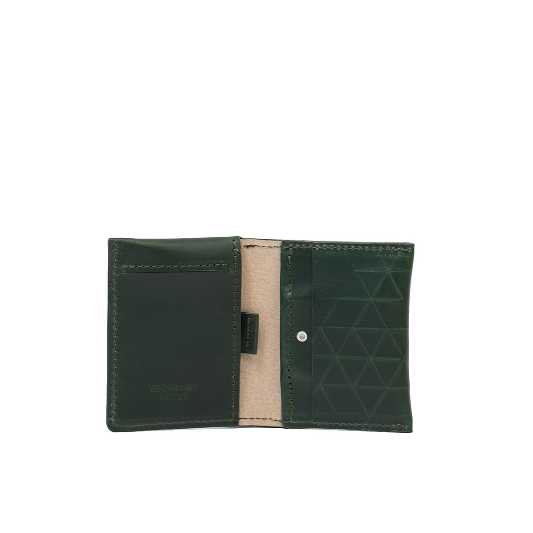 Open view of green leather AirTag card wallet with geometric vector design and card slots.