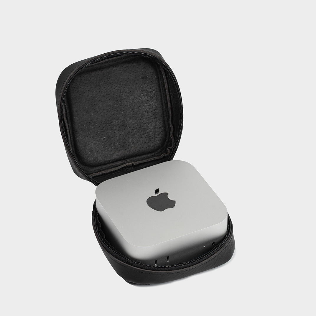 Black leather Mac Mini case displayed next to a Mac Mini, showcasing its custom fit and elegant design