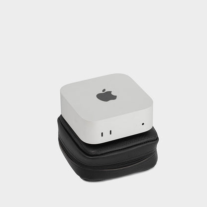 Black leather case with Mac Mini stacked neatly, emphasizing portability and sturdy construction.