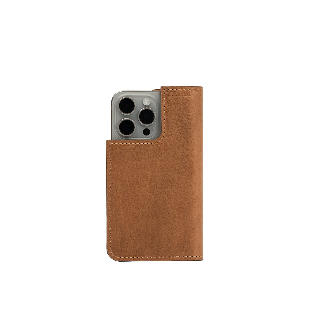 Brown leather iPhone 16 folio case displayed flat, highlighting its elegant texture and craftsmanship.