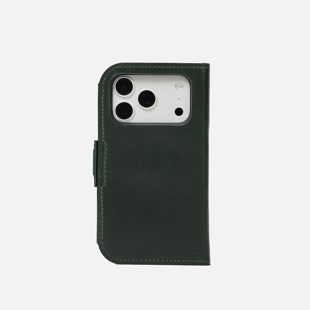 Closed dark green leather iPhone Air folio wallet; magnetic tab and rear camera opening visible – Geometric Goods