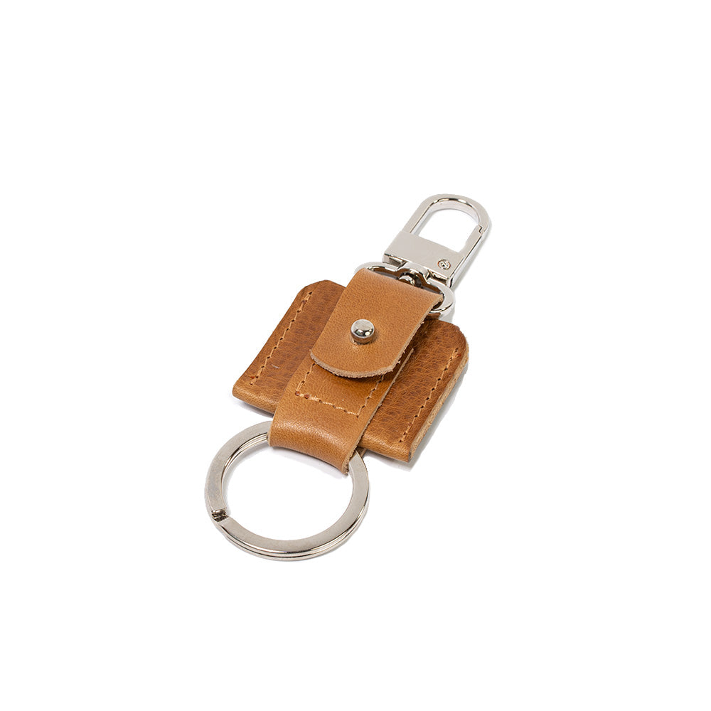 AirTag keychain with a convenient snap hook and keyring attachment made from Italian full-grain vegetable-tanned leather in camel light brown color