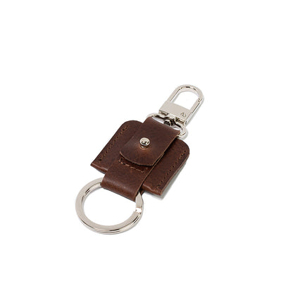 AirTag keychain with a convenient snap hook and keyring attachment made from Italian full-grain vegetable-tanned leather in dark brown mahogany color