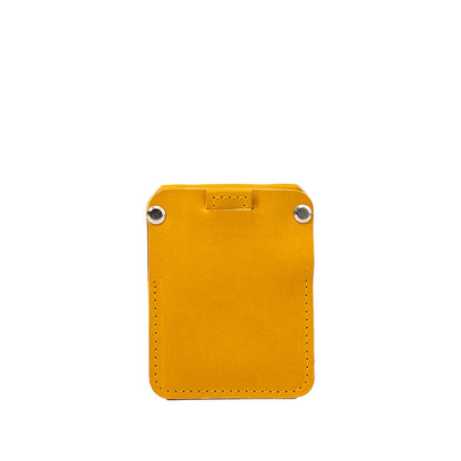 Yellow leather AirTag wallet The Minimalist by Geometric Goods, featuring clean front with silver rivets and rear card slot