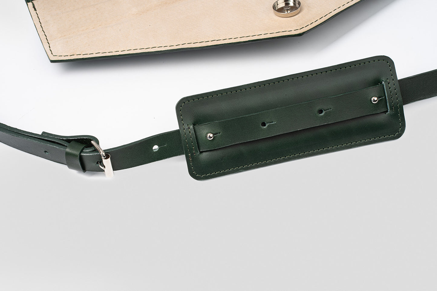 Adjustable crossbody strap on a green leather ladies briefcase, featuring a comfortable shoulder pad and secure clasps, perfect for daily professional use.