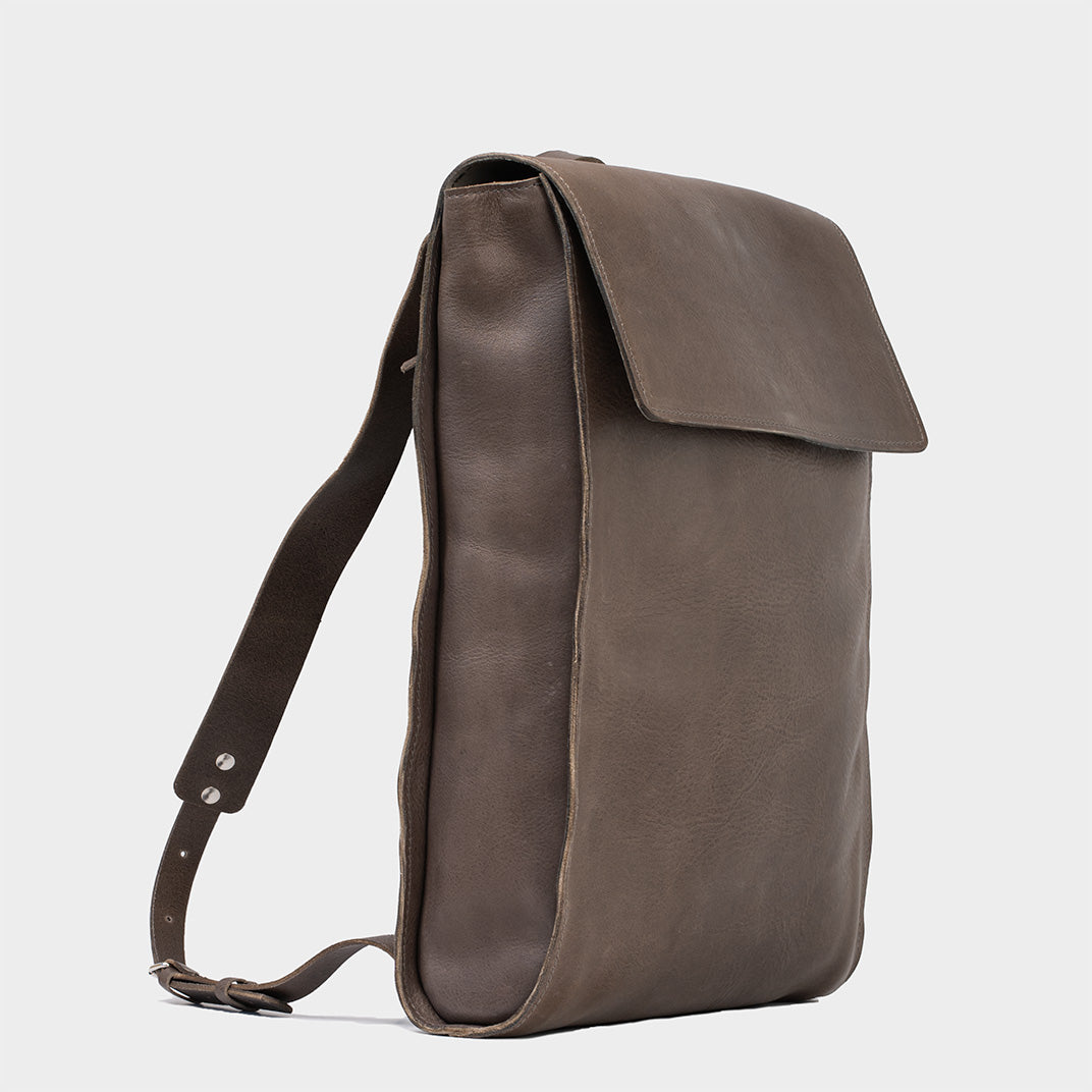 Leather laptop backpack - The Minimalist in gray, showcasing side view with sleek design and durable straps
