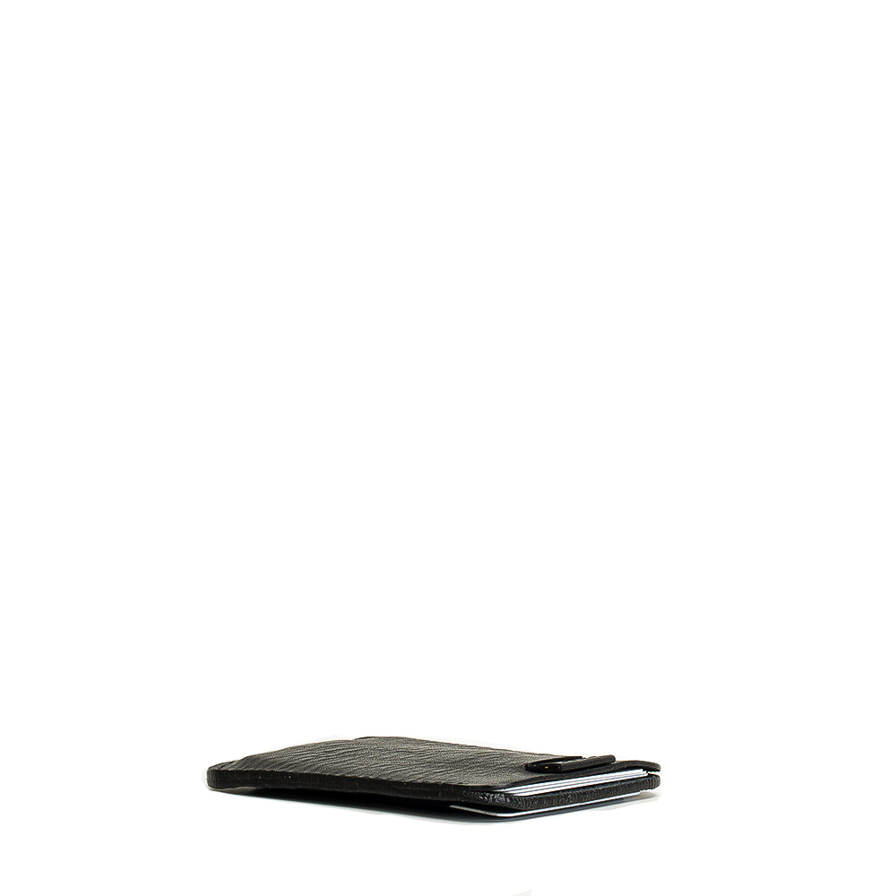 Designer sleek black full-grain leather wallet, open to show its slim profile and compartments for cards and cash