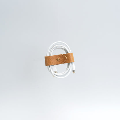 the photo of vintage-style cord organizer made from full-grain leather by Geomeric Goods in camel color