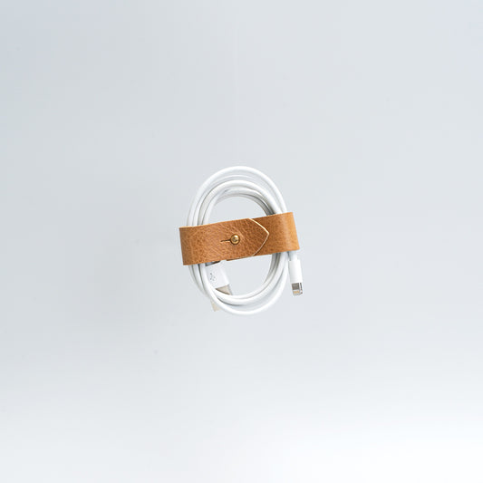 the photo of vintage-style cord organizer made from full-grain leather by Geomeric Goods in camel color