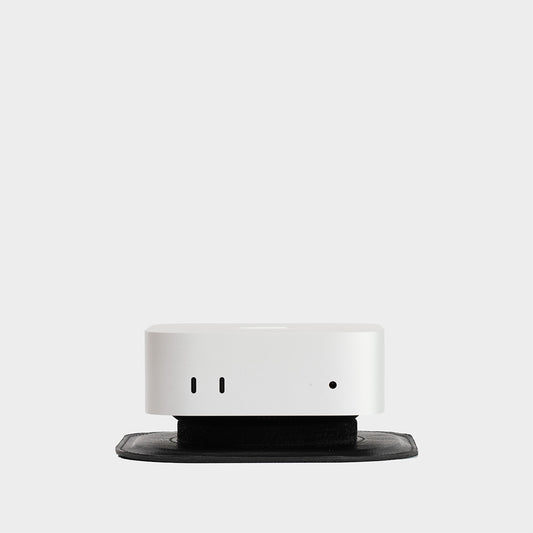 Black leather Mac Mini M4 stand on a desk, holding a Mac Mini securely, designed for minimalistic desk setups.