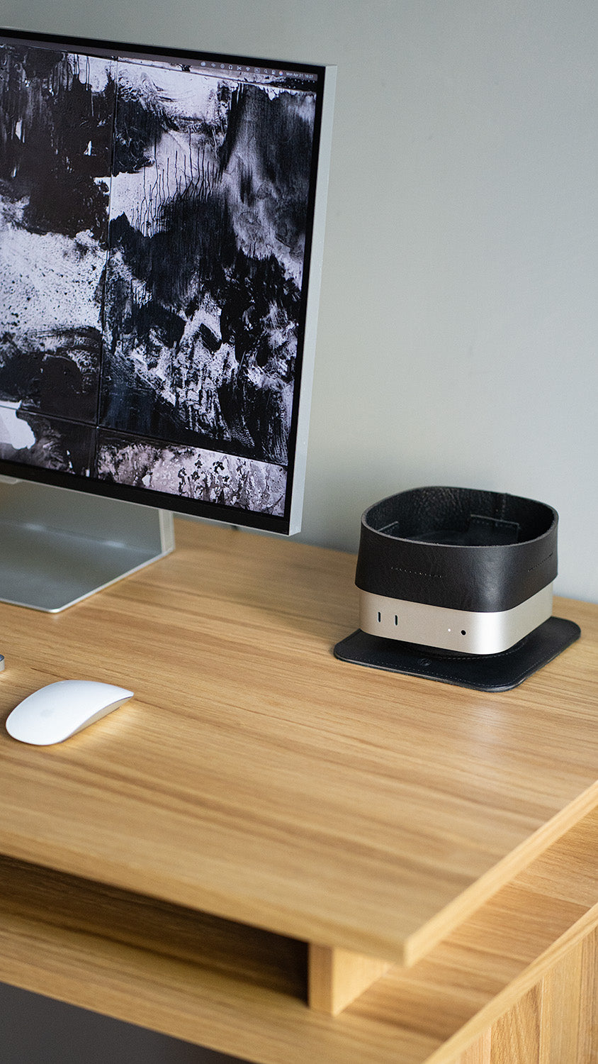 Full workspace view with Mac Mini leather tray – minimalist black organizer atop Mac Mini beside monitor and mouse