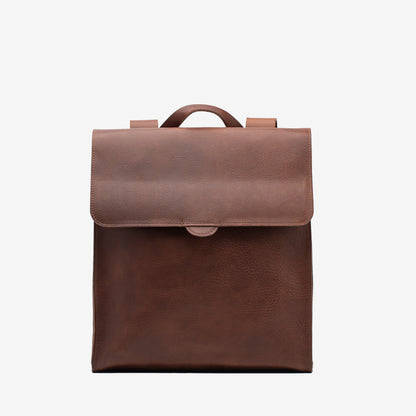 Front view of the mahogany Leather Backpack – Fibonacci with a wide flap closure and top carry handle