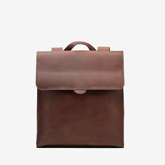 Front view of the mahogany Leather Backpack – Fibonacci with a wide flap closure and top carry handle
