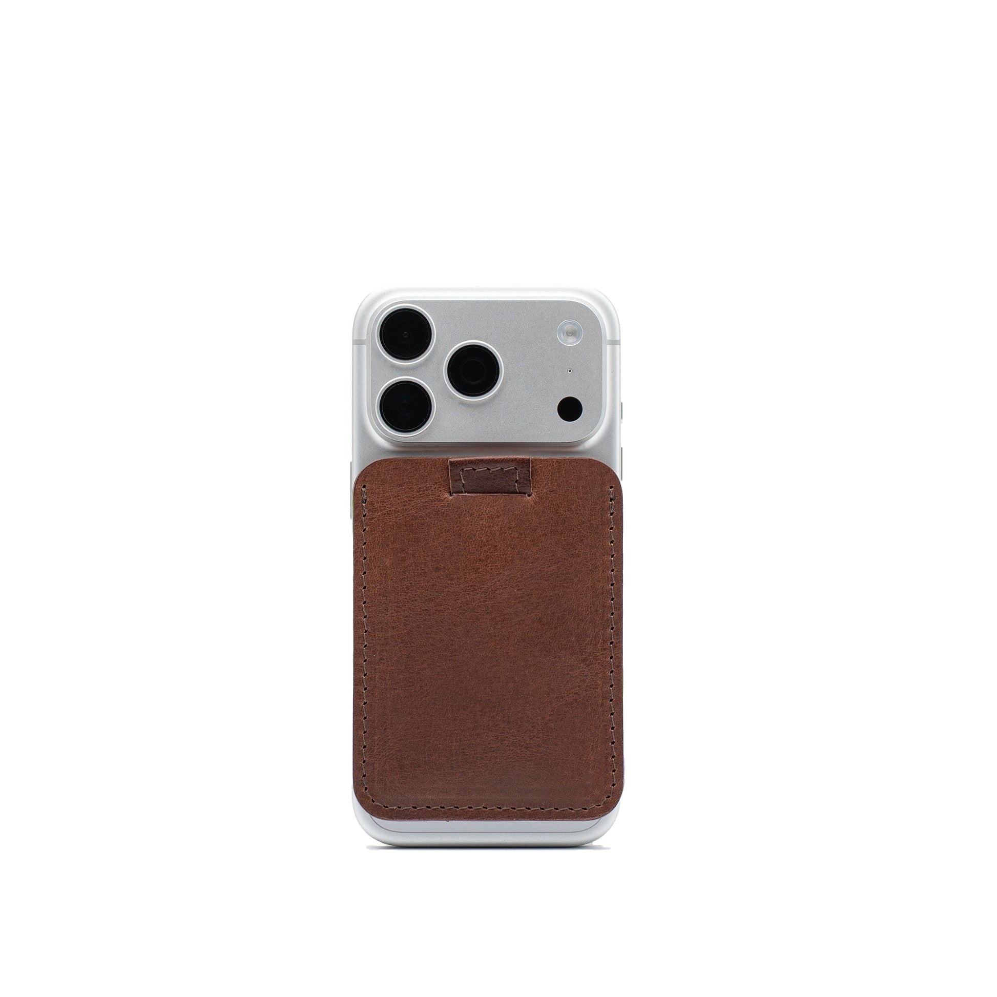 Mahogany leather wallet compatible with MagSafe attached to a silver iPhone, with pull tab at the top