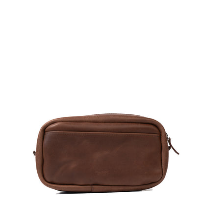 Mahogany leather organizer bag with adjustable strap attached, showcasing its adaptability and comfort for daily use