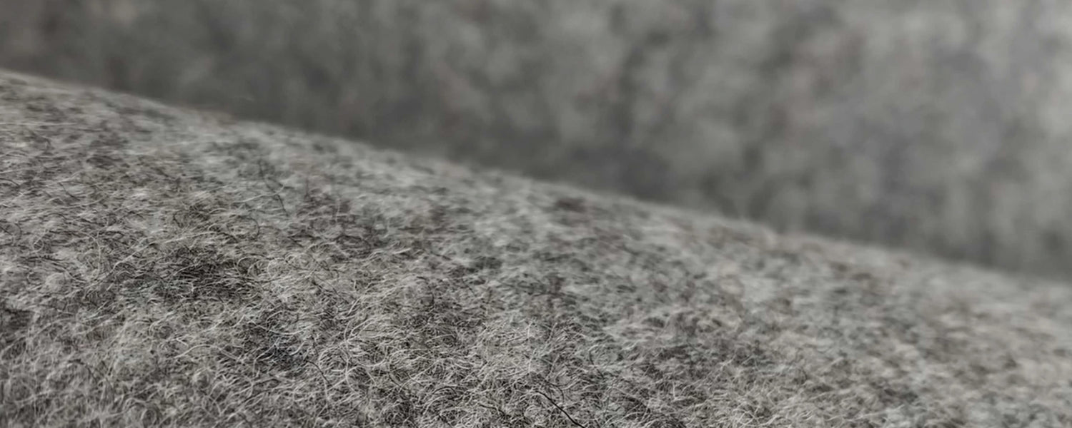 Grey merino wool felt texture shown in detail—dense fibers visible.