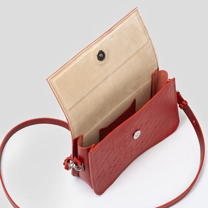 Interior view of red shoulder bag open to show beige lining and built-in pockets