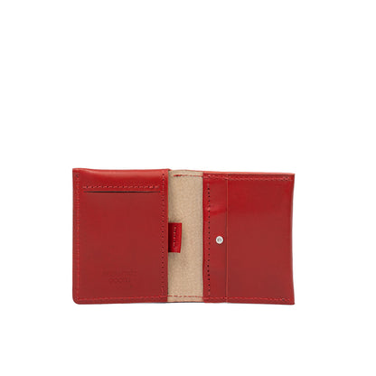 Open view of red leather AirTag card wallet with visible compartments for cards