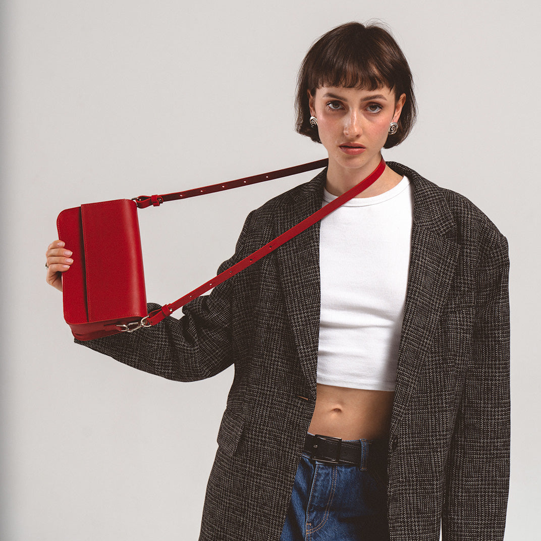 Red Leather Shoulder Bag - Curie by Geometric Goods, versatile and modern design, worn crossbody by a stylish woman in a casual outfit