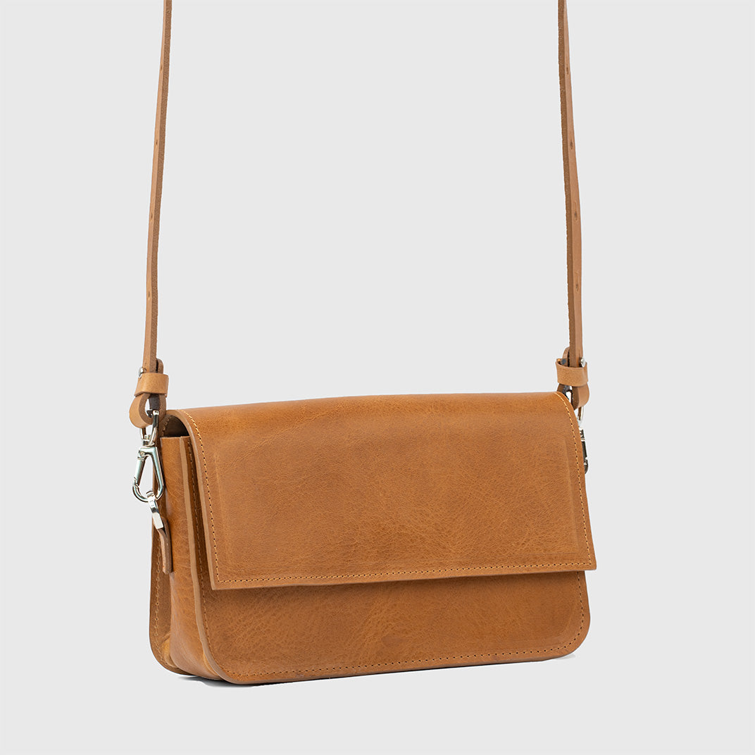 light brown leather shoulder purse with structured design and adjustable strap.