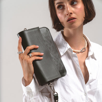 Shoulder bag - Leather Shoulder Bag in Green Vectors held by a woman in a white shirt showcasing its geometric pattern design