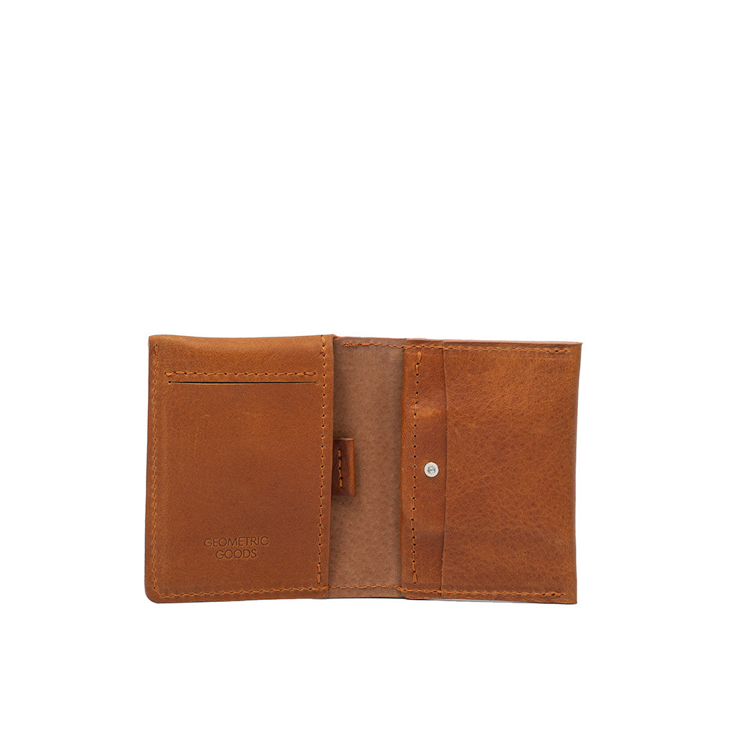 Open view of tan leather AirTag card wallet showing card slots and hidden AirTag pocket.