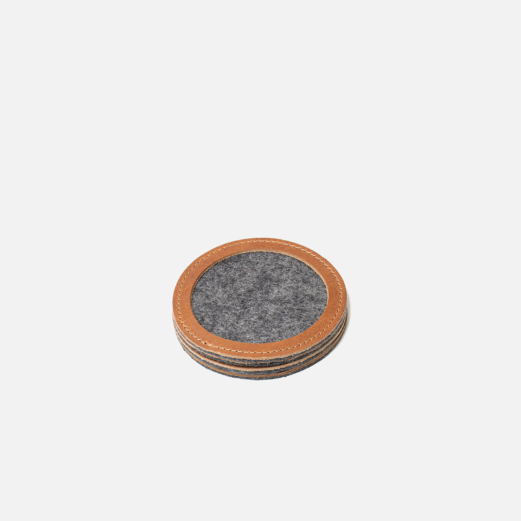 Stack of round wool felt coasters with brown leather rims, 3.86 in (98 mm) diameter