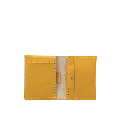 Open view of yellow leather AirTag card wallet highlighting card slots and hidden AirTag pocket
