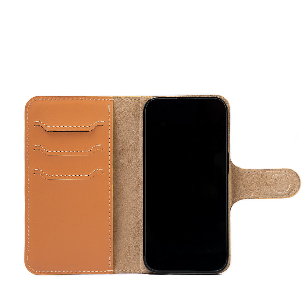iPhone 14 folio case with MagSafe made from top-grain vegetable tanned leather in light orange color by Geometric Goods leather workshop