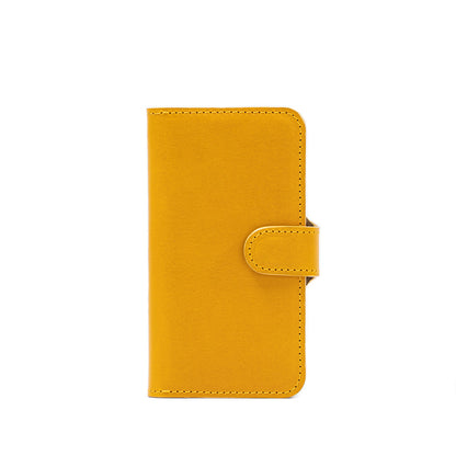 font side of iPhone 14 folio case with MagSafe made from top-grain vegetable tanned leather in yellow color by Geometric Goods leather workshop