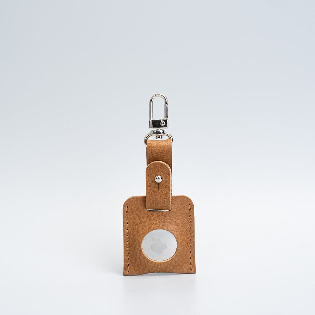 light brown bag charm with carabiner airtag