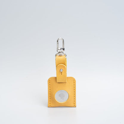 mustard yellow bag charm with carabiner airtag