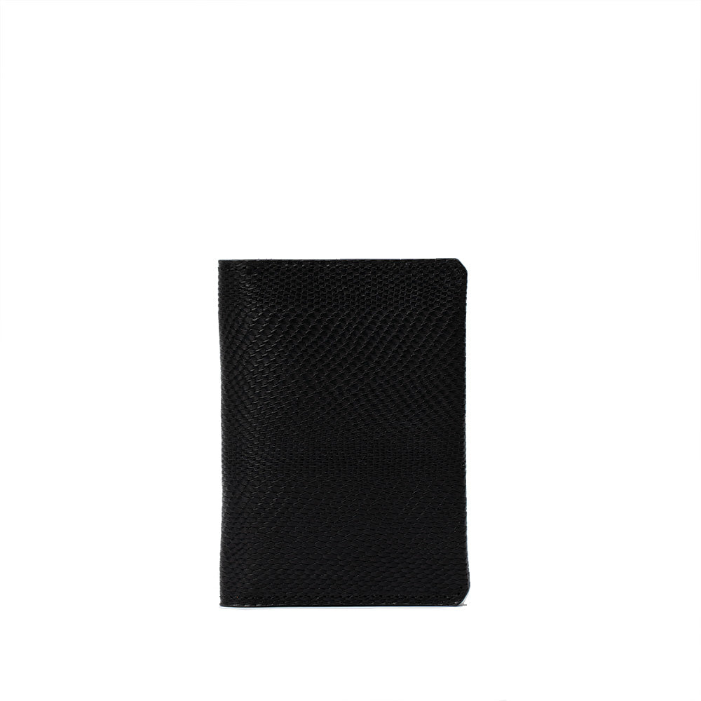 Image of a luxury black snake-print leather AirTag passport wallet from Geometric Goods. With a secret slot for AirTag. Crafted from premium Italian leather.