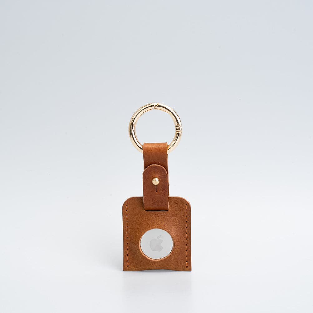 tan airtag keyring with golden carabiner